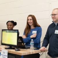 people talking in front of a senior project